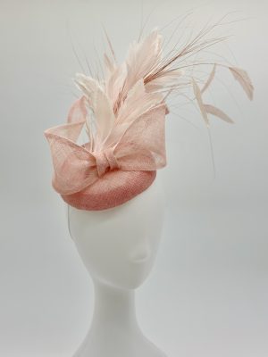 Racewear, occasion wear, wedding guest millinery. A rosewater pink cocktail button hat made of sinamay, with pink and white sculptural sinamay bow and feather tree by Australian Milliner, Abigail Fergusson. Designed in Sydney Australia.