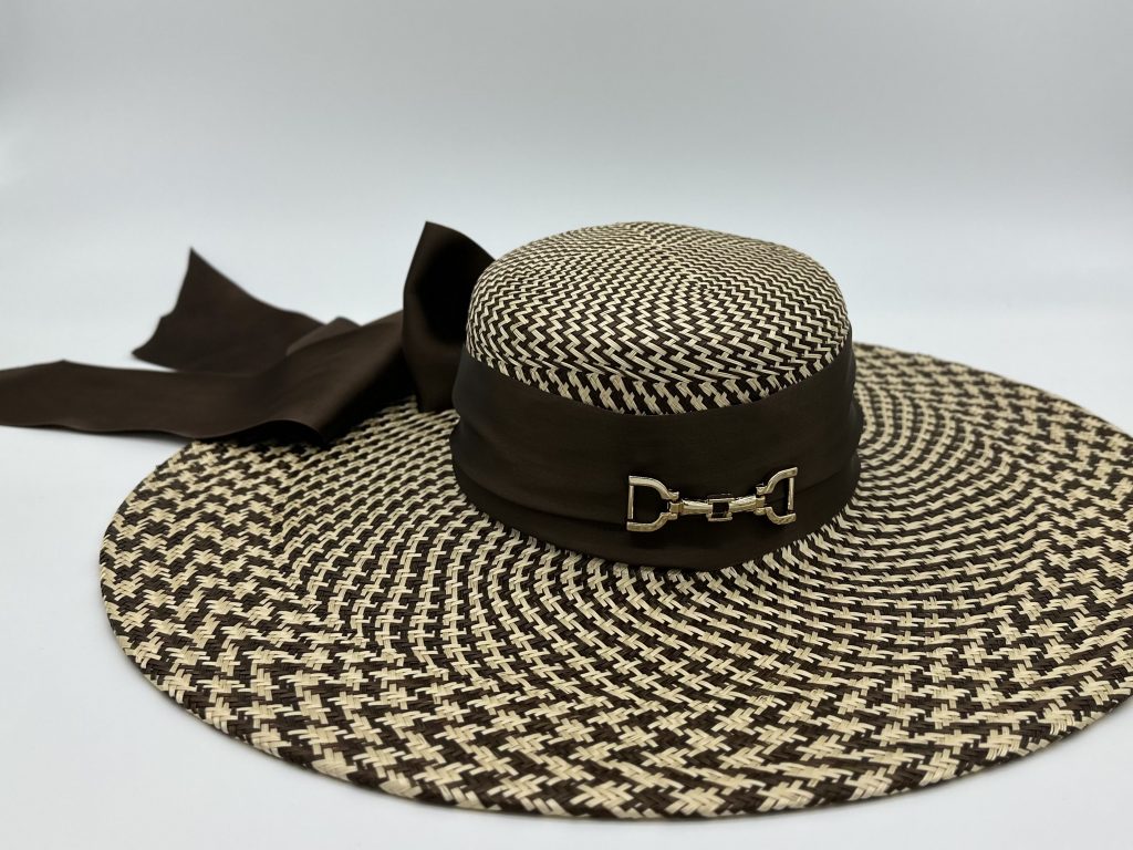 Spring Racing Racewear Polo in the City Urban Polo Big Big Brimmed Sun hat in natural and chocolate brown pattern with big flowing brown satin bow and gold horse saddle snaffle bit trim hardware by Australian Milliner Sydney Milliner Hatmaker Abigail Fergusson Millinery
