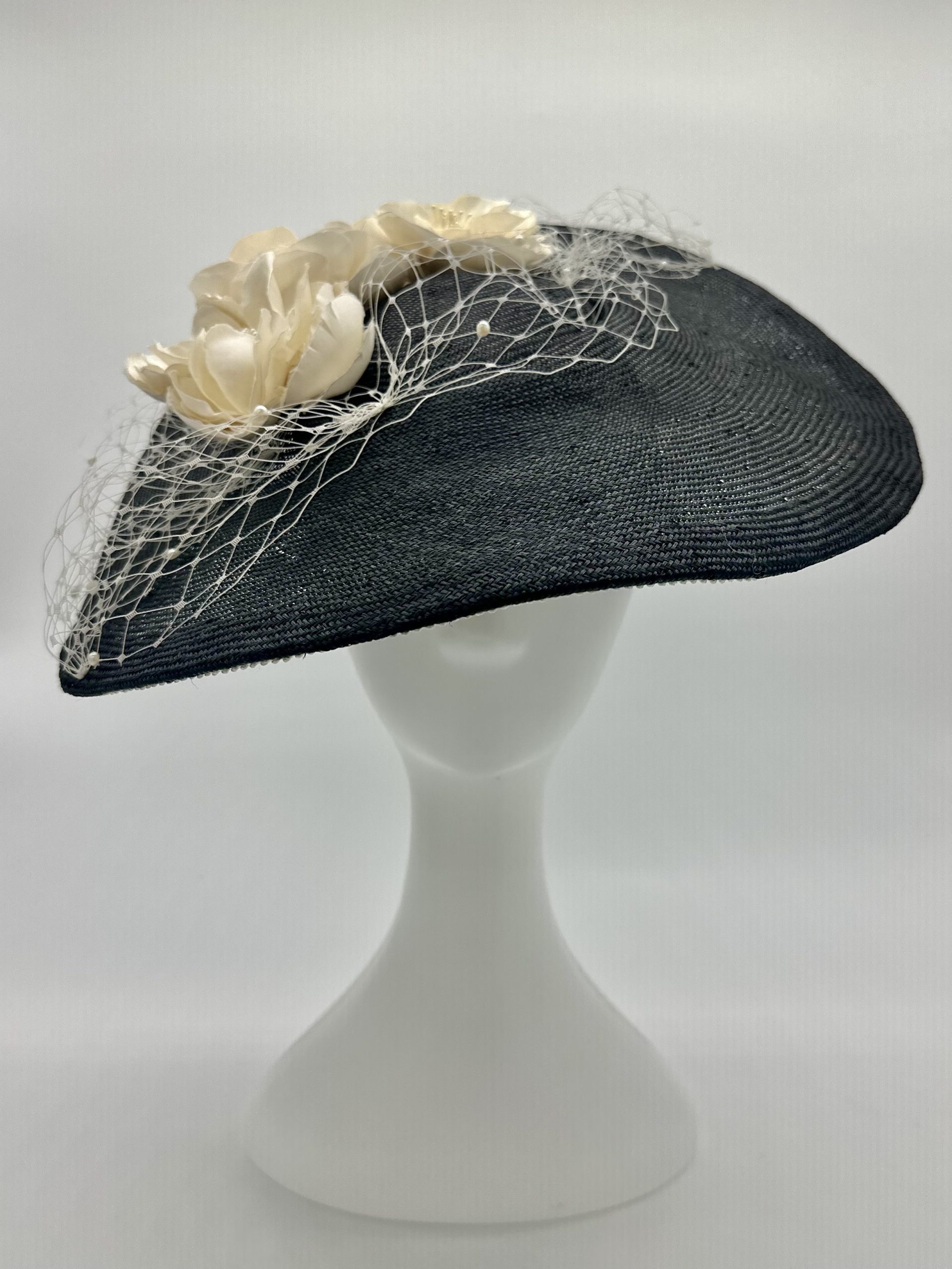 Monochrome Black and ivory saucer hat with ivory silk roses and pearl merry widow veiling and lace braid trim by Australian Milliner Abigail Fergusson available instore at the Milliner's Closet perfect for Championships Day 1 or Derby Day racewear