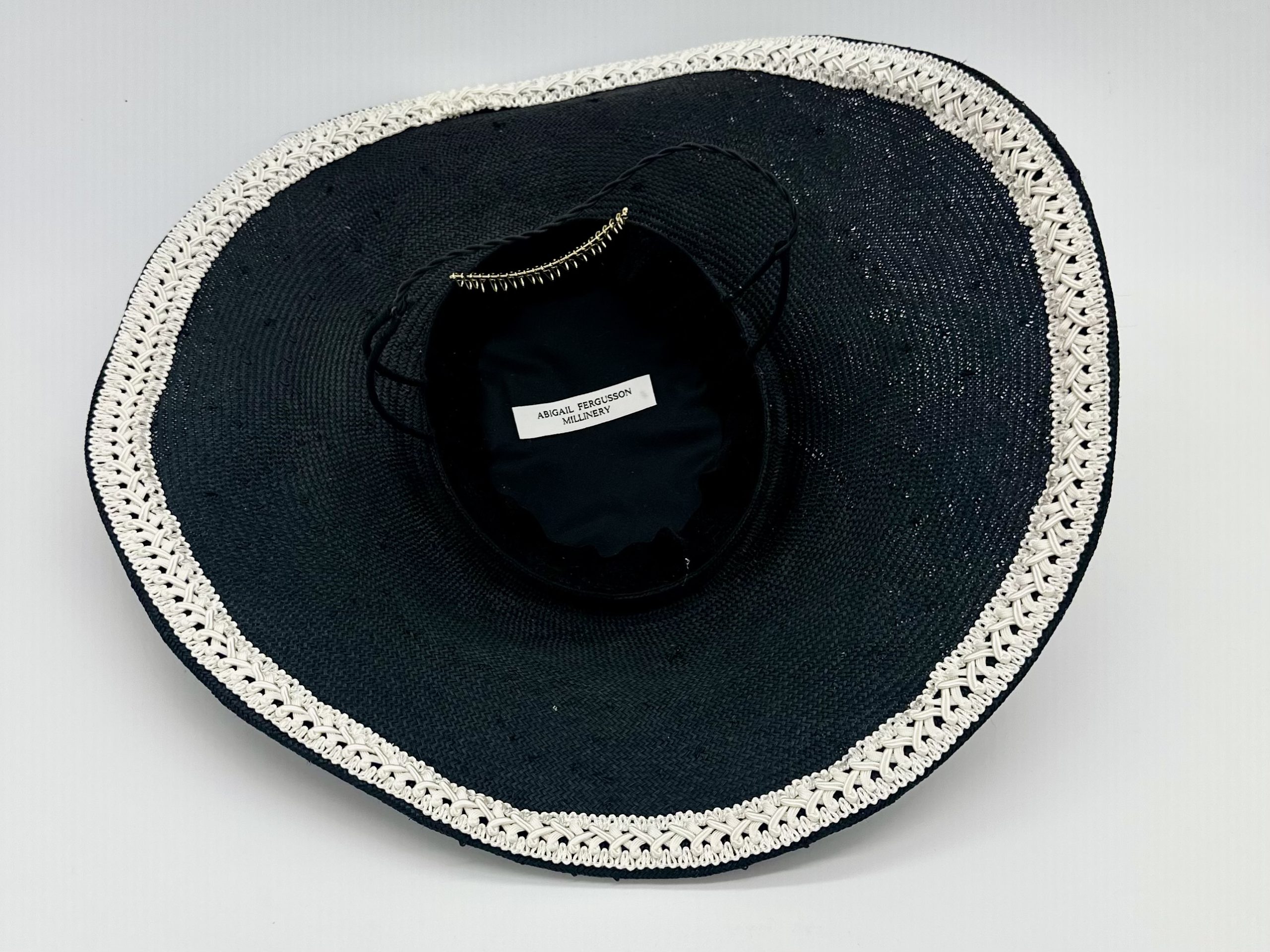 Monochrome Black and ivory saucer hat with ivory silk roses and pearl merry widow veiling and lace braid trim by Australian Milliner Abigail Fergusson available instore at the Milliner's Closet perfect for Championships Day 1 or Derby Day racewear