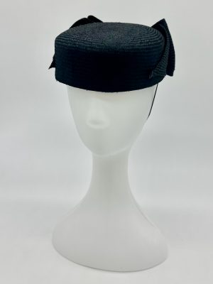 FOTF Fashions on the Field Spring Racing Millinery Racewear black Parasisal pillbox hat, trimmed with black bow and mother of pearl button by Australian Milliner, Abigail Fergusson Millinery, in store at The Milliner's Closet in Balgowlah in Sydney's Northern Beaches, perfect for the Derby Day, Melbourne Cup, The Everest, Magic Millions Carnivals.